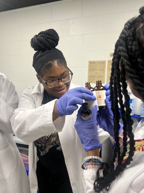 Youth making soap products for the BEUTEAFUL enterprise